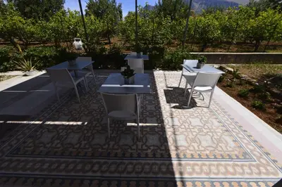a group of tables and chairs on a patio at Miss Sicily B&B in Terrasini