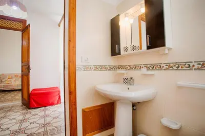 a bathroom with a sink and a mirror at GuestHost - Castellammare Stella Apartments in Castellammare del Golfo