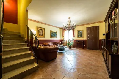 a living room with a staircase and a couch at Bed And Breakfast Marina d'Aspra in Bagheria