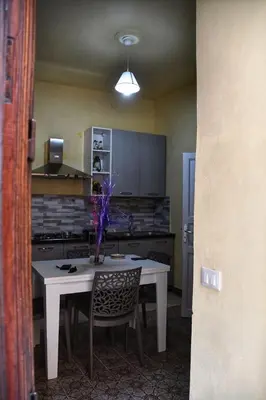 a kitchen with a table with a vase on it at L' Arco Antico in Caccamo
