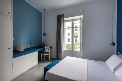 a room with a glass door and a table and chairs at Casa Azul alla Cala by Wonderful Italy in Palermo