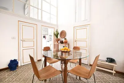 a dining room with a glass table and chairs at iFlat Casa Ponticello Kemonia in Palermo