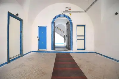 an empty room with a blue door and a red carpet at iFlat Casa Ponticello Kemonia in Palermo