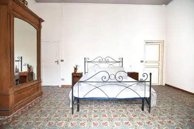a bedroom with a bed and a large mirror at iFlat Casa Ponticello Kemonia in Palermo