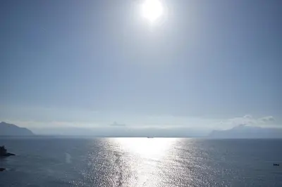 a large body of water with the sun in the sky at Vero Sicily - Villa Acqua Chiara in Bagheria