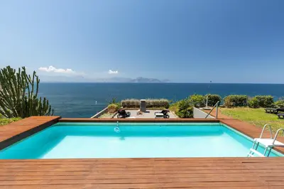 a swimming pool with a view of the ocean at Vero Sicily - Villa Acqua Chiara in Bagheria