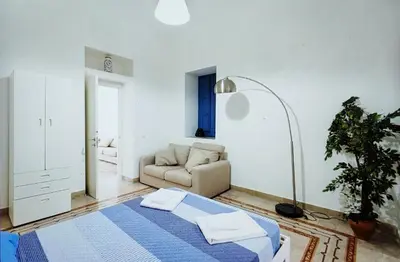 a living room with a bed and a couch at Star Politeama apartment, in centro città. in Palermo