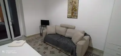 a living room with a couch and a television at Star Politeama apartment, in centro città. in Palermo