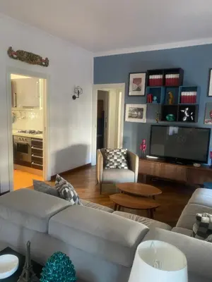 a living room with a couch and a tv at MONTE PELLEGRINO HOUSE AND TERRACE in Palermo