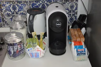 a coffee maker sitting on a counter with food at La casetta nel verde in Palermo