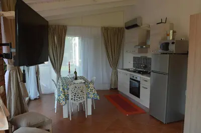 a kitchen and dining room with a table and chairs at La casetta nel verde in Palermo