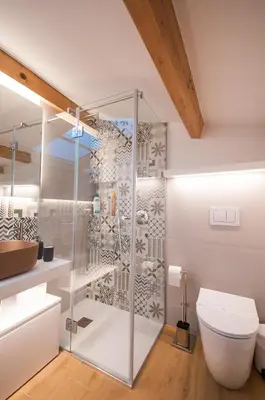 a bathroom with a glass shower stall and a toilet at White Home in Castellammare del Golfo