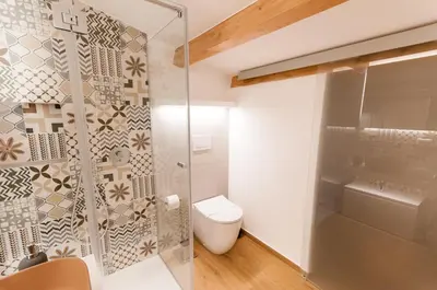 a bathroom with a toilet and a glass shower at White Home in Castellammare del Golfo
