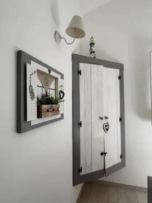 a medicine cabinet and a mirror on a wall at Marilù Casa Vacanza in San Vito lo Capo