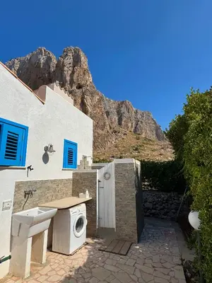 a bathroom with a sink and a washing machine at Marilù Casa Vacanza in San Vito lo Capo
