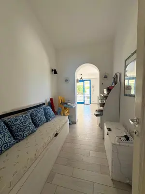 a living room with a couch and a hallway at Marilù Casa Vacanza in San Vito lo Capo