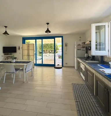 a kitchen with a table and a dining room at Marilù Casa Vacanza in San Vito lo Capo
