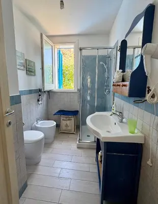 a bathroom with a toilet and a sink and a shower at Marilù Casa Vacanza in San Vito lo Capo