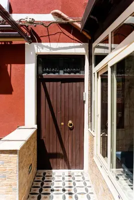 a wooden door of a house with a window at Gennaro Holidays in Corleone