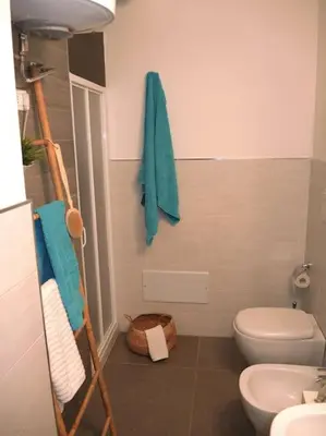 a bathroom with a white toilet and a sink at Makari Bay Home in San Vito lo Capo