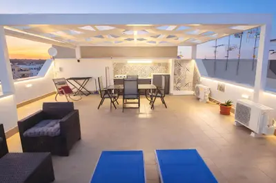 a living room with blue mats on a balcony at Appartamento Dolceluna in San Vito lo Capo