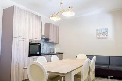 a kitchen and dining room with a wooden table and chairs at Gennaro Holidays Appartament in Corleone
