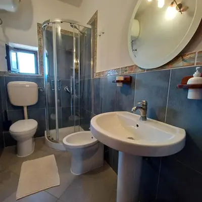 a bathroom with a sink and a toilet and a mirror at Genius Home in Palermo
