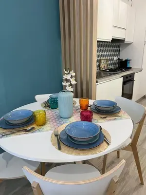 a white table with plates on it in a kitchen at Ca San Vito Lo Capo Villa Maria in San Vito lo Capo