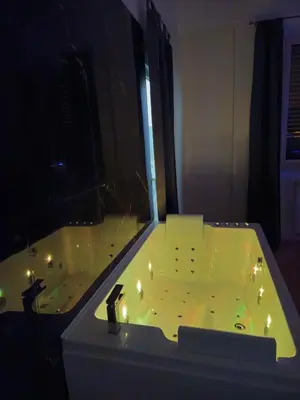 a bathroom with a tub with lights in it at Simone Cupolas View in Palermo