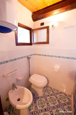 a bathroom with a toilet and a sink at Baglio 