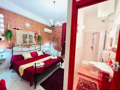 a bedroom with a bed and a brick wall at Regina Elena in Cinisi