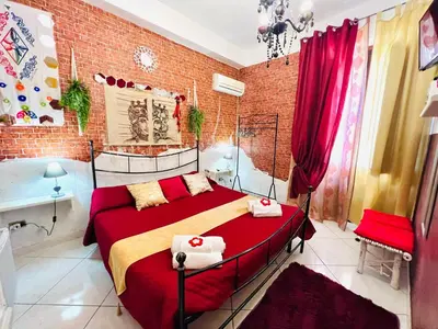 a bedroom with a bed and a brick wall at Regina Elena in Cinisi