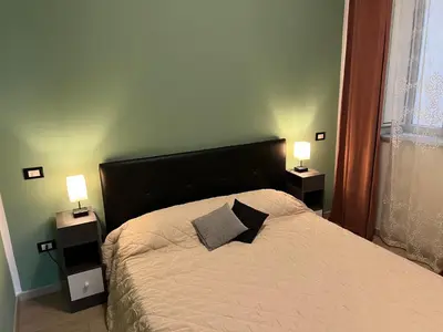 a bedroom with a bed with two lamps on it at Via Serradifalco, Zona Via Dante in Palermo