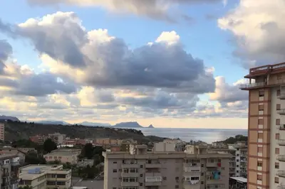 a view of a city with buildings and the ocean at Sicilian Apartment in Termini Imerese