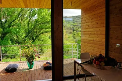 a room with a balcony with a view of a forest at Il Bevaio Di Corleone in Corleone