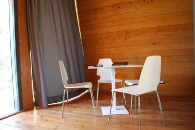 two white chairs and a table with a laptop on it at Il Bevaio Di Corleone in Corleone