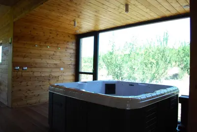 a jacuzzi tub in a room with windows at Il Bevaio Di Corleone in Corleone
