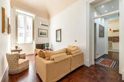 a living room with a couch and a chair at Casa Goethe delle Volte by Wonderful Italy in Palermo