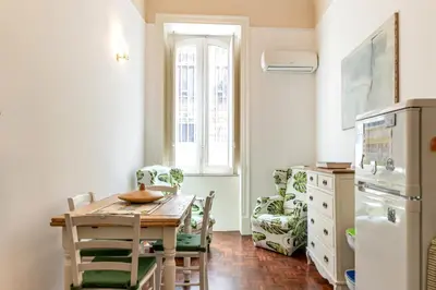 a kitchen with a table and chairs in a room at Casa Goethe delle Volte by Wonderful Italy in Palermo