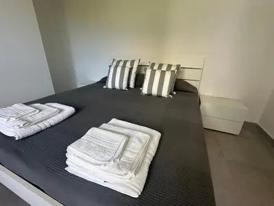 a bedroom with a bed with towels on it at Villa Oasi Verde in Cinisi