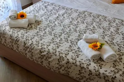 a bed with towels and flowers on top of it at TALO' - casa vacanze in Palermo