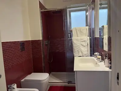 a bathroom with a shower and a toilet and a sink at Wave house in Palermo