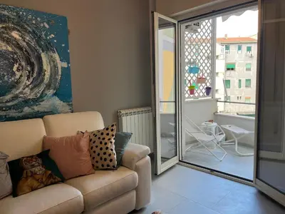 a living room with a couch and a large window at Wave house in Palermo