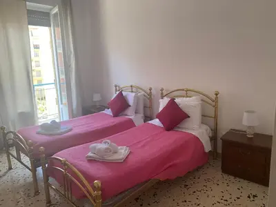 a bedroom with two beds with towels on them at Serradifalco Cozy House di Enza e Luigi in Palermo
