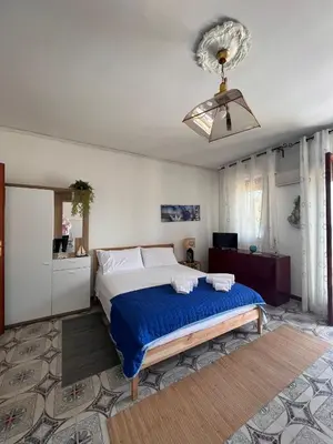 a bedroom with a bed and a ceiling fan at Rocca Mondello Rooms, Beach and Sea in Palermo