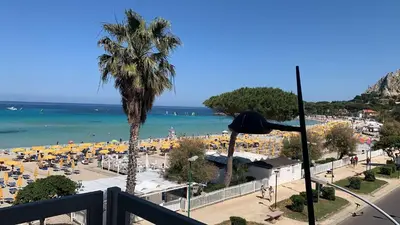a balcony with a view of a beach at Rocca Mondello Rooms, Beach and Sea in Palermo