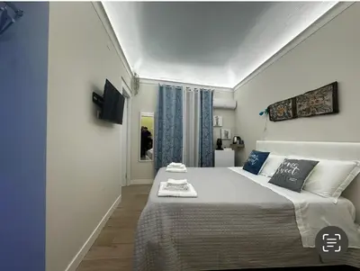 a bedroom with a large bed in a room at Daria's home apartment rooms in Palermo