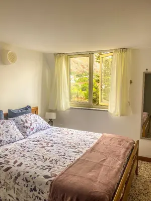 a bedroom with a bed and a window at Casetta della Muri in Isola delle Femmine