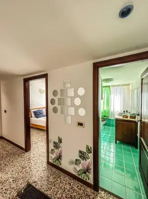 a room with a hallway with a bedroom and a bathroom at Casetta della Muri in Isola delle Femmine