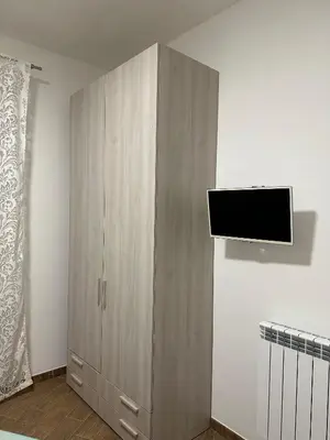 a hallway with a white door and a sign on a wall at SAMMARTINO LUXURY APARTMENT in Palermo